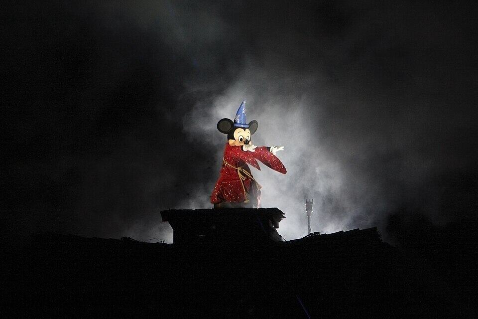 Sorcerer Mickey in a blue hat and red robe during Disneyland’s Fantasmic! show in 2009.